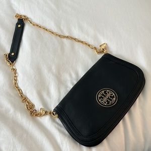 Black leather and gold hardware clutch and crossbody Tory Burch bag.